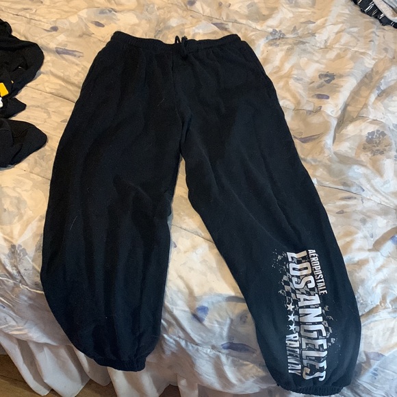 Black aero joggers, w/ white/grey lettering down one leg - Picture 2 of 3